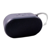 Small dark gray portable speaker with fabric grille and strap on white