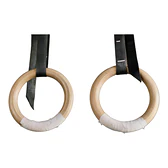 Pair of wooden gymnastic rings with black straps on white